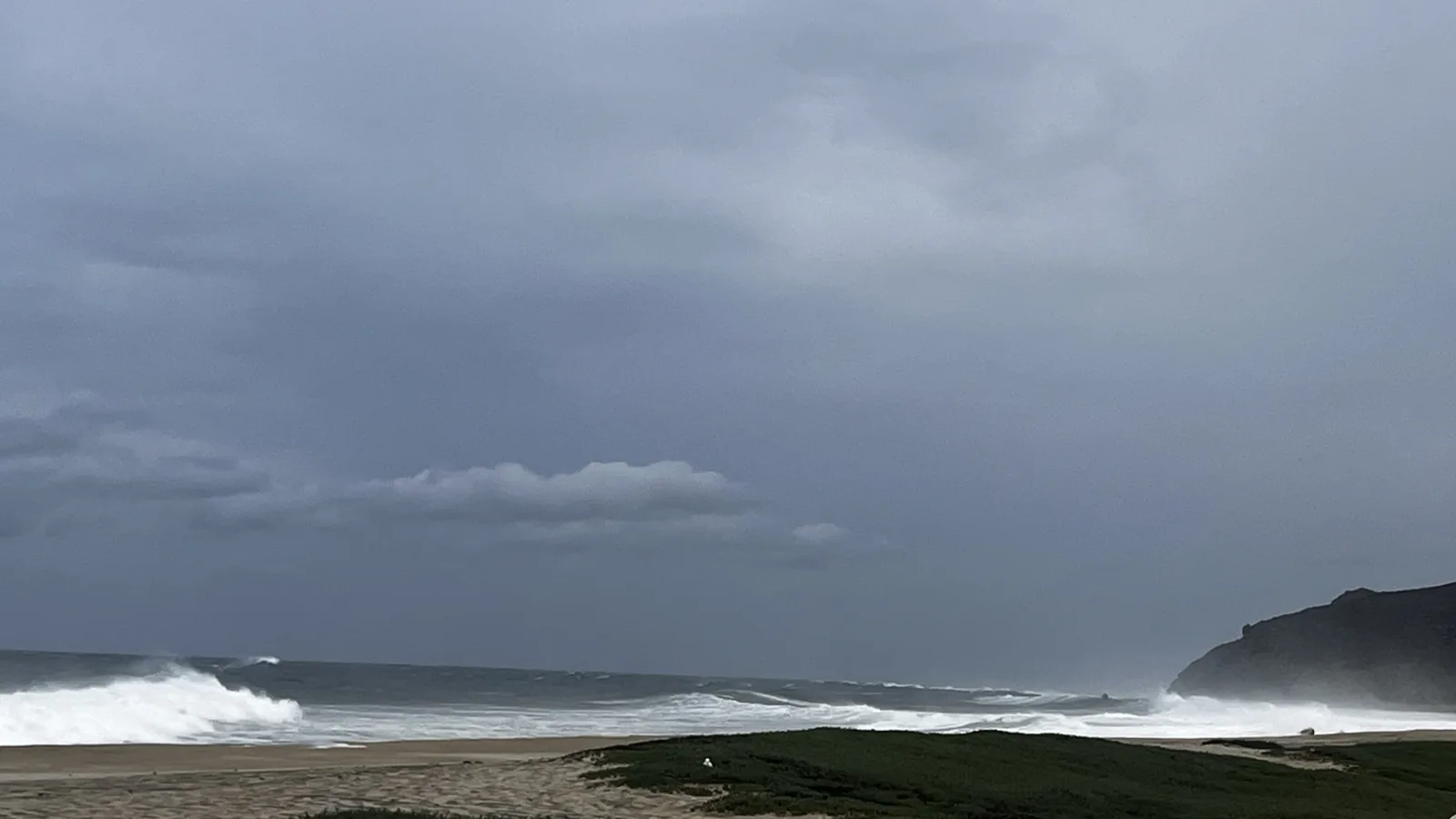 Storm clouds and large surf along the El Pescadero coast