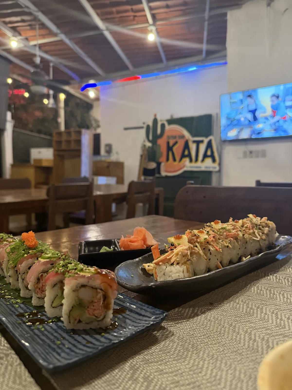 Two sushi rolls on a table inside Sushi Bar Kata
